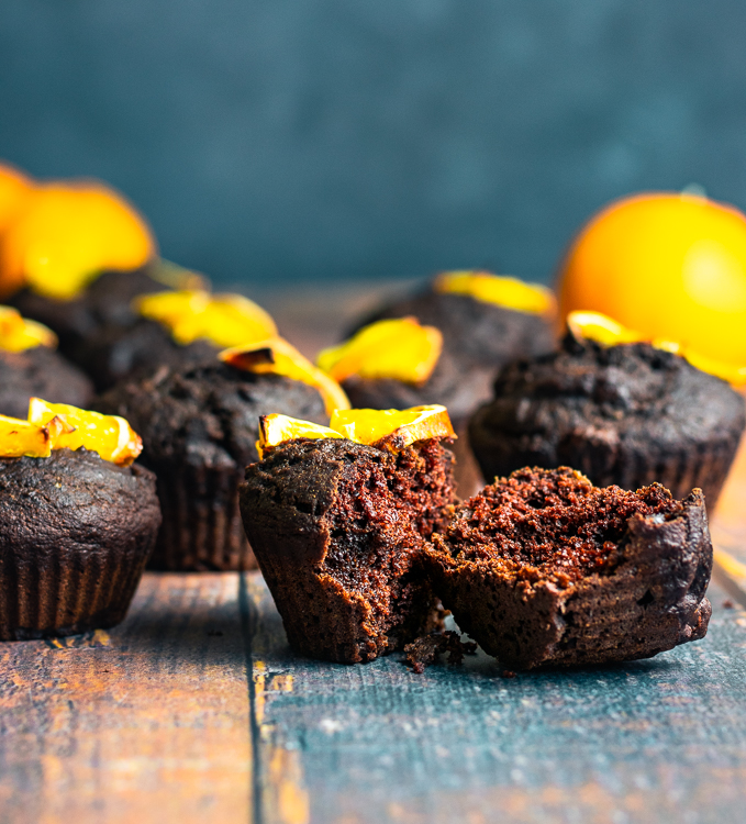 chocolate orange muffins placed on table, one split in half