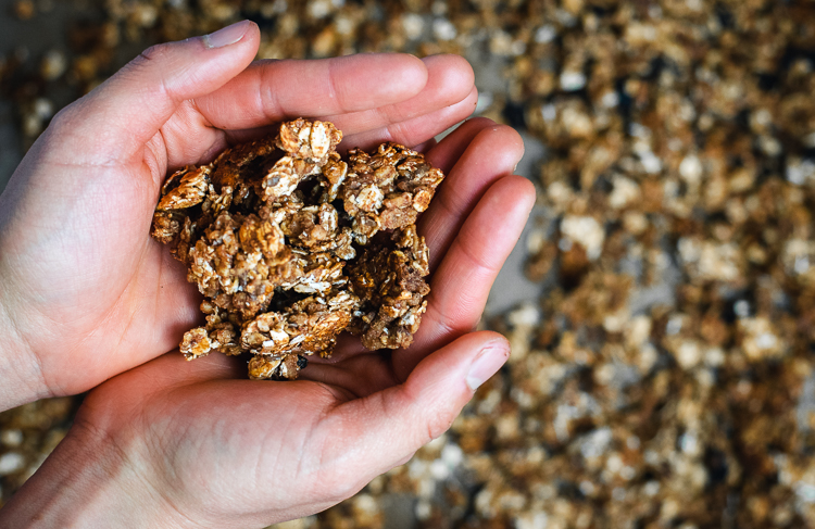oatmeal cookie granola after baking, clusters held in hands