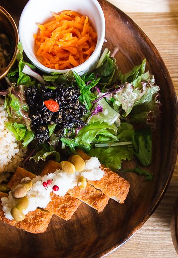 lunch set from Musubi Cafe in Kyoto, includes tofu katsu, salad, rice, soup, pickles, juice, and 2 veggie side dishes