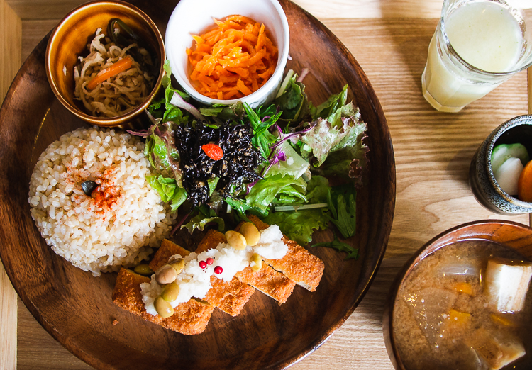 lunch set from Musubi Cafe in Kyoto, includes tofu katsu, salad, rice, soup, pickles, juice, and 2 veggie side dishes