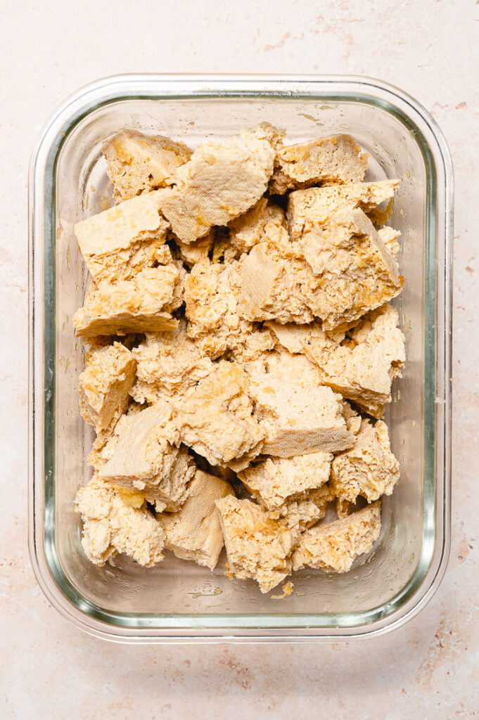 frozen and thawed tofu being marinated