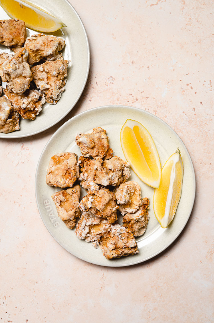 tofu karaage on plates with lemon slices