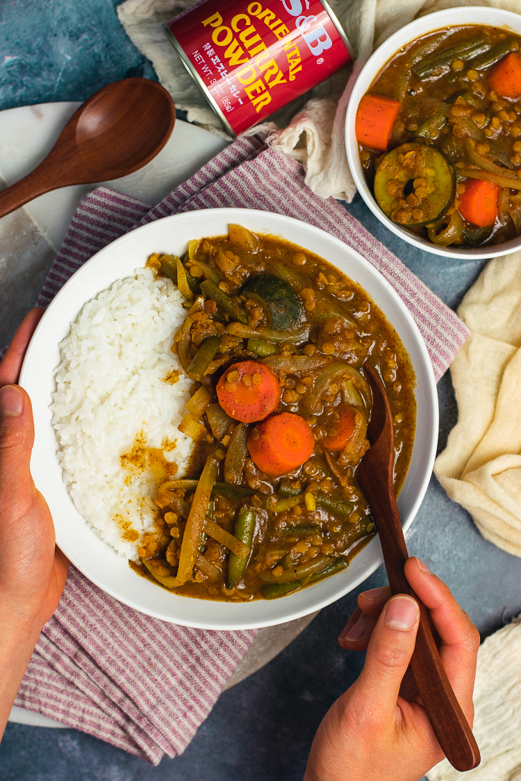 vegan japanese curry served in bowl with rice and spoon