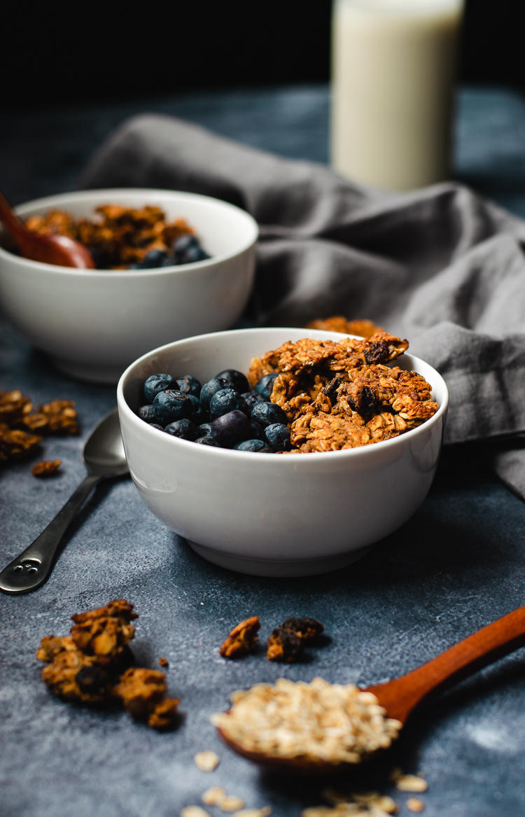 oatmeal cookie granola served in bowls with blueberries
