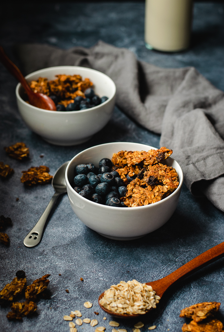 oatmeal cookie granola served in bowls with blueberries