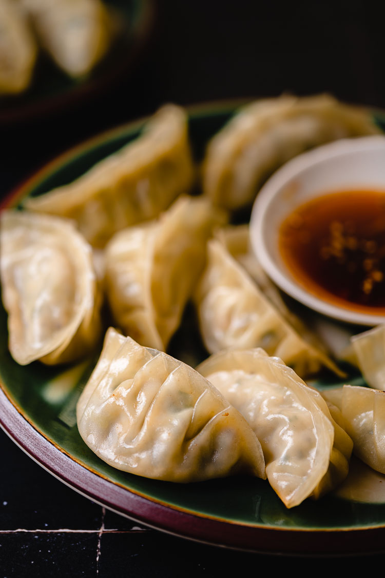 gyoza on a plate with dipping sauce