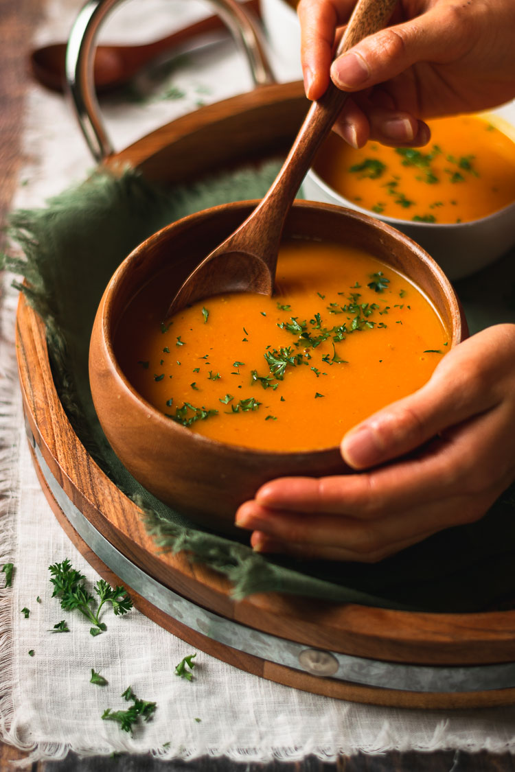 vegan kabocha soup in a bowl with a spoon