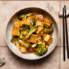 chili sauce tofu and broccoli in a bowl