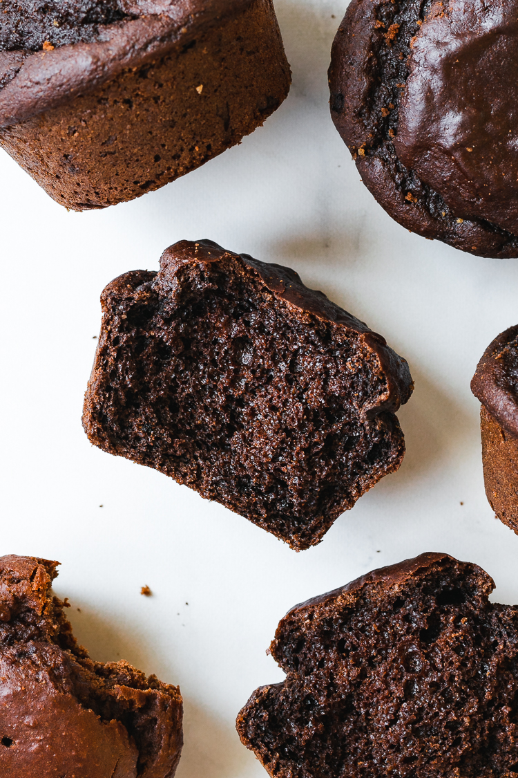 flatlay of chocolate muffin cross section surrounded by more muffins