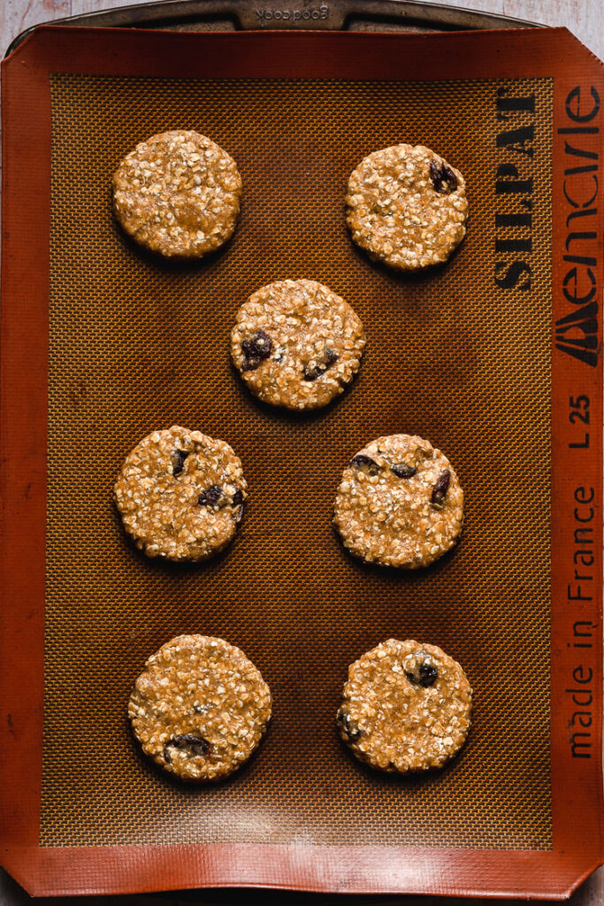 vegan oatmeal raisin cookies on baking sheet prebake