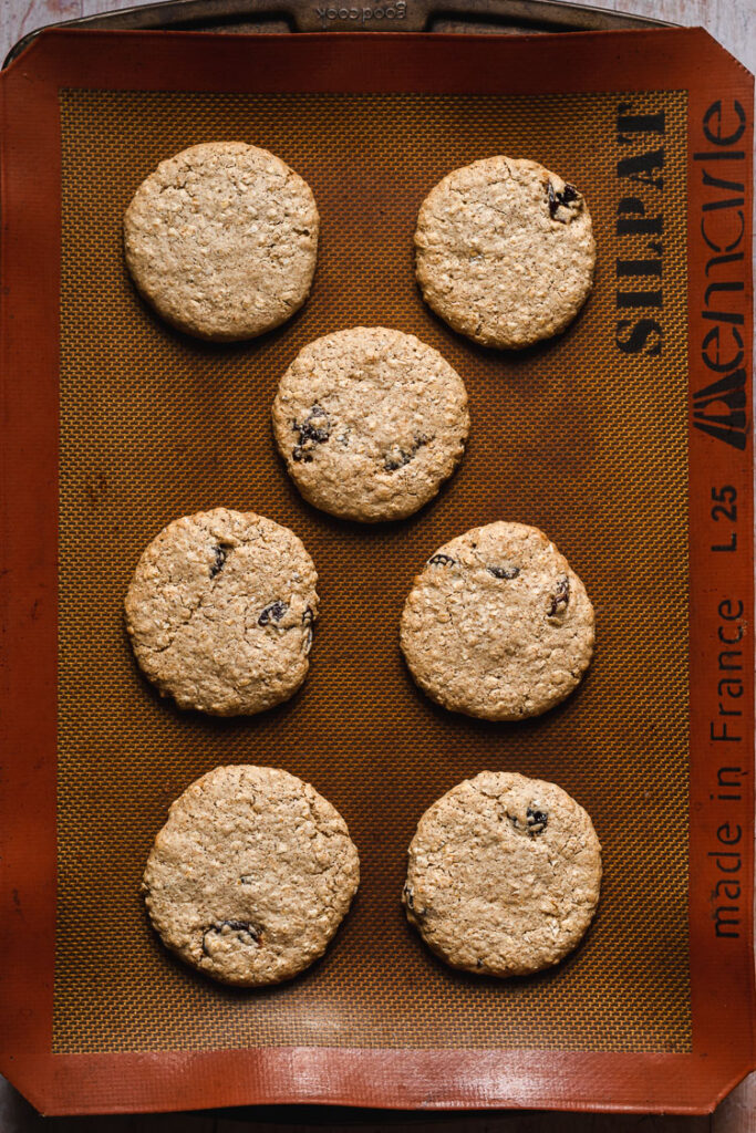 vegan oatmeal raisin cookies on baking sheet after baking