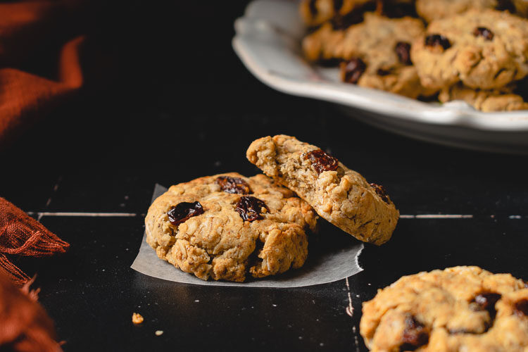 two oatmeal raisin cookies staggered on top each other