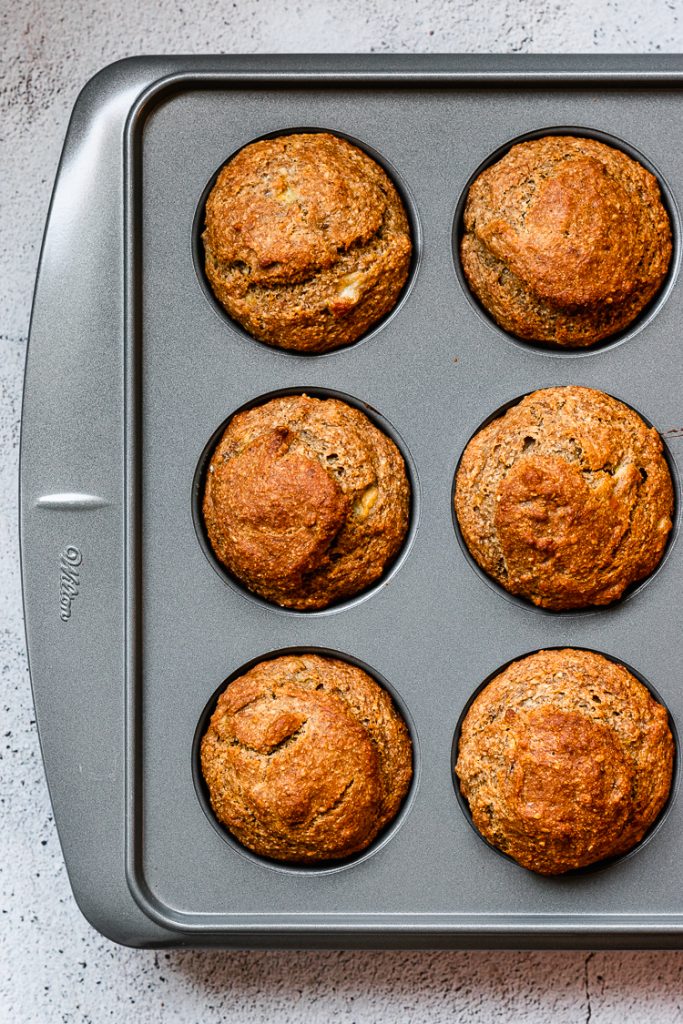 vegan sesame banana muffins after baking, still in muffin pan