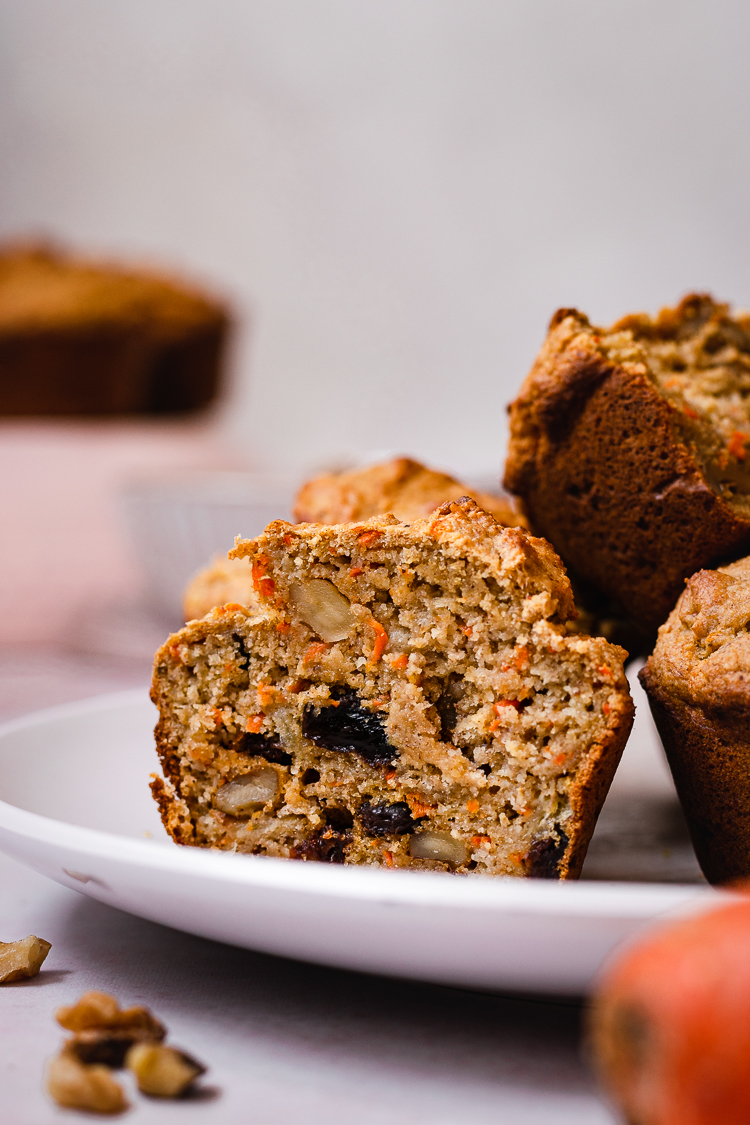 cross section of vegan carrot banana muffin on a plate