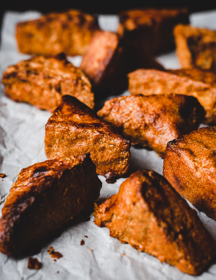 close up of hoisin peanut tempeh on parchment paper after cooking