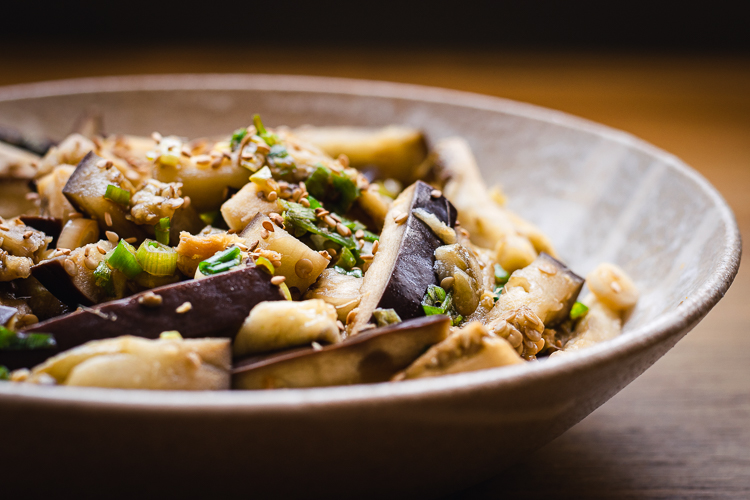 steamed eggplant with green onion dressing in a bowl