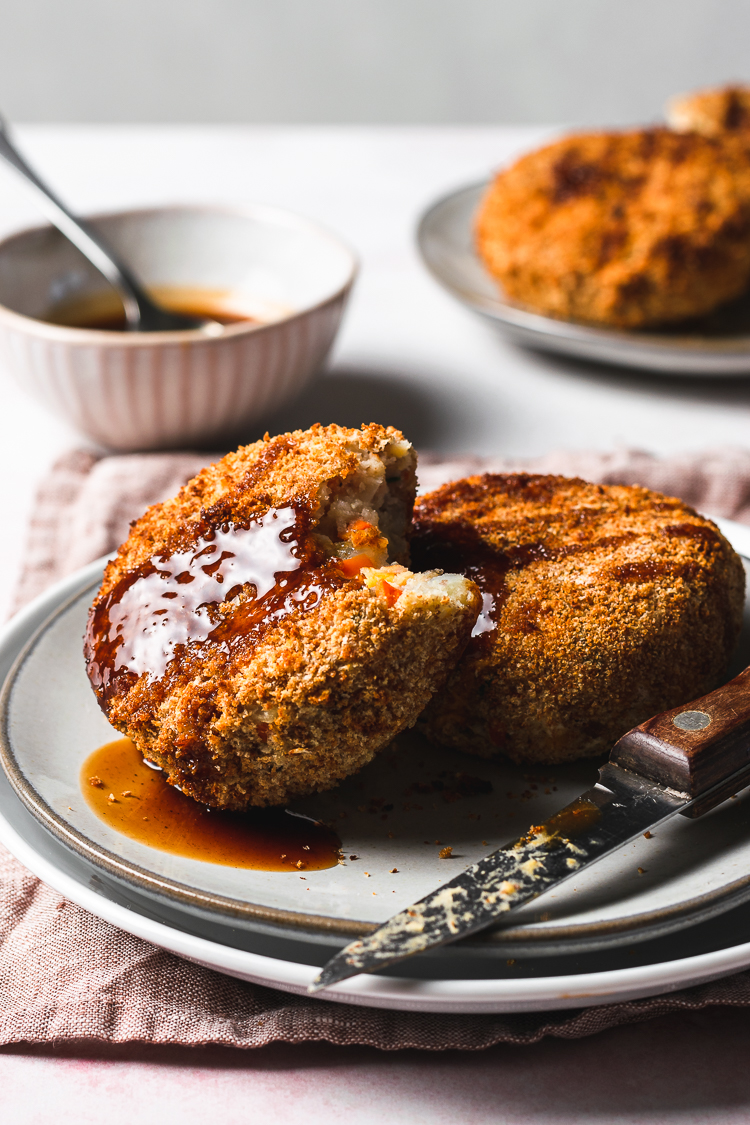 vegan white bean korokke on a plate with a bite taken out of it