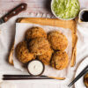 white bean korokke on a plate with mayo and worcestershire sauce