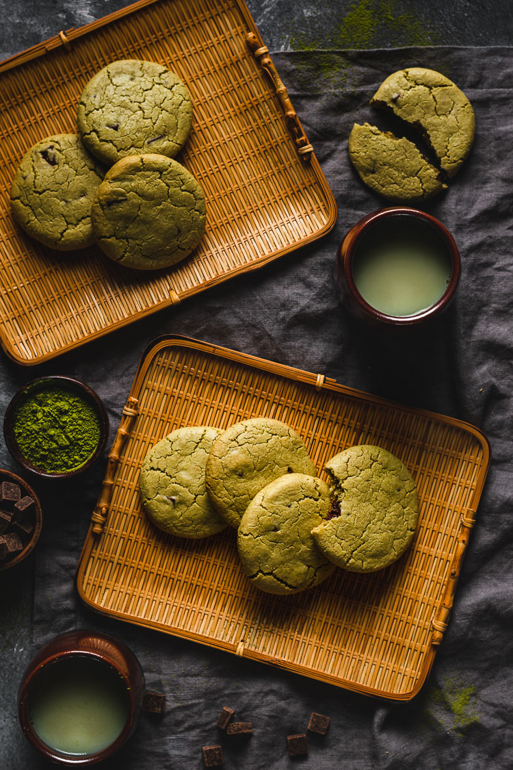 vegan matcha cookies arranged on serving platters with hot matcha tea on the side