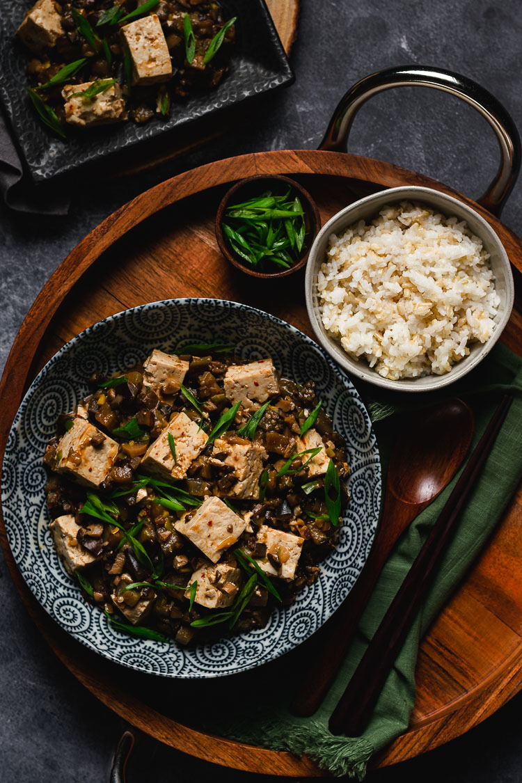 vegan mapo tofu in a bowl with rice on the side
