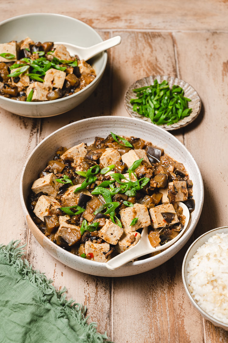 two bowls of mapo tofu, rice bowl in corner