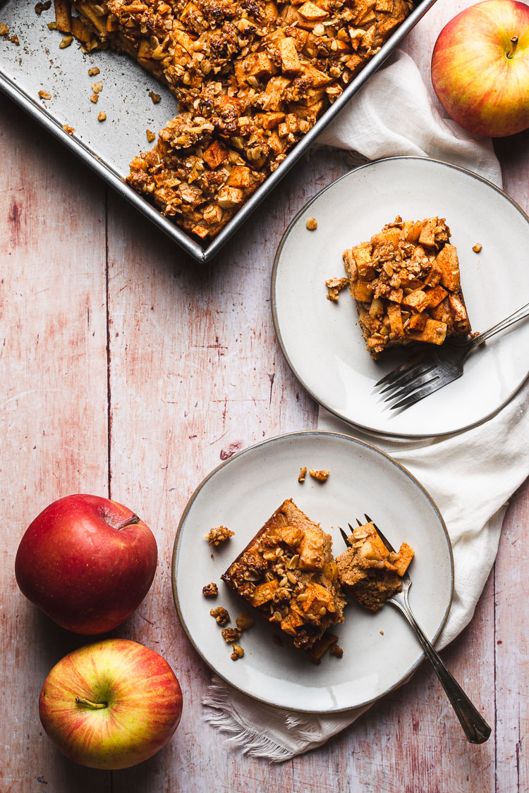 two pieces of apple crumb cake on separate plates