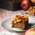 a piece of vegan apple crumb cake on a plate with a fork