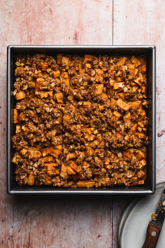 baked vegan apple crumb cake cut in slices