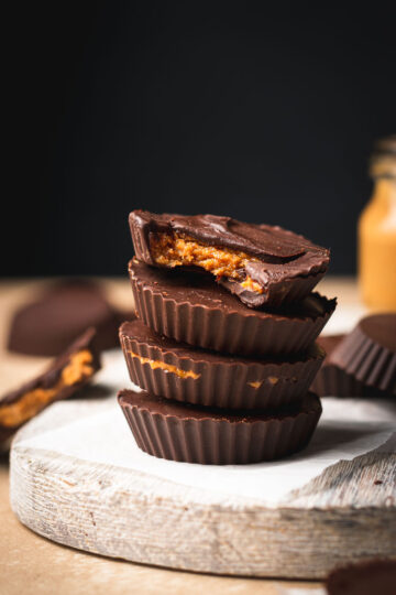peanut butter cups stacked on top of each other, bite taken out of two