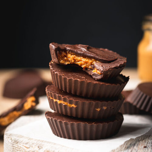 peanut butter cups stacked on top of each other, bite taken out of two