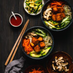 two bowls of tempeh bibimbap with fillings on the side