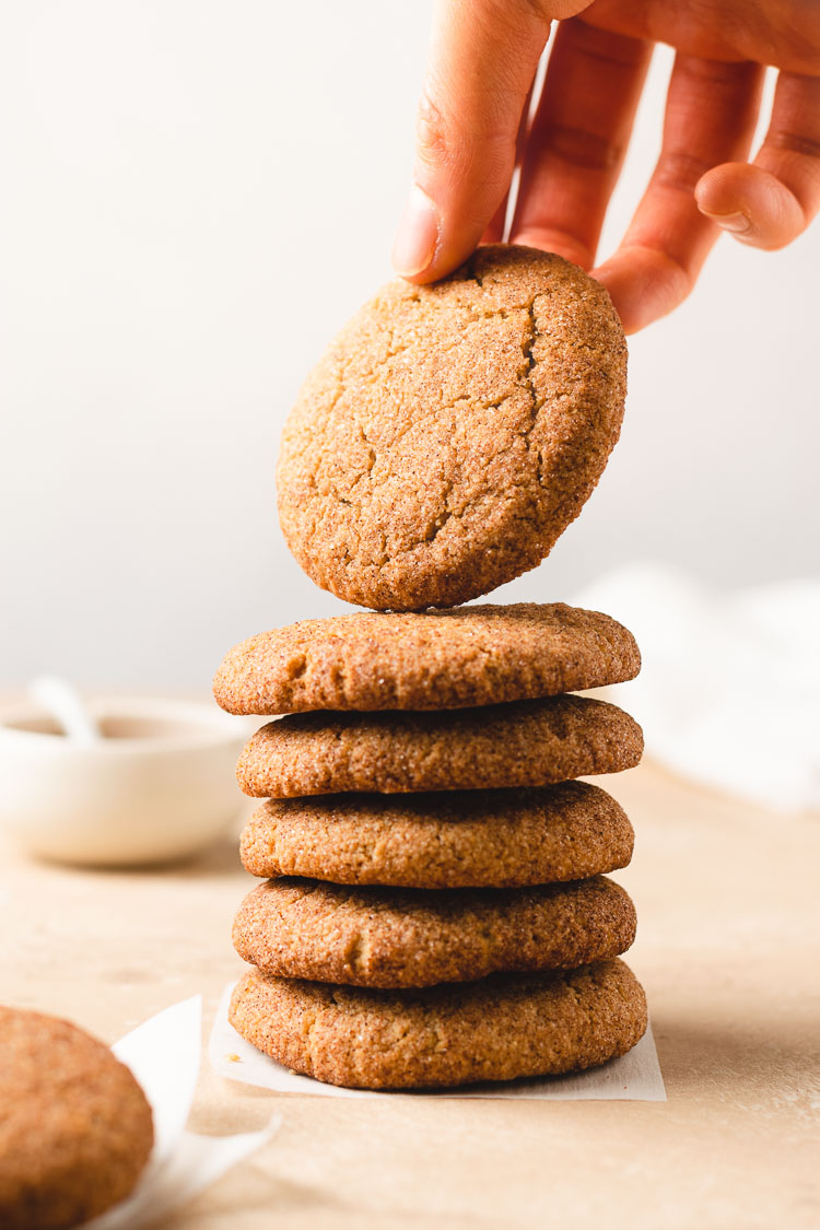 stack of snickerdoodles with a hand reaching for one
