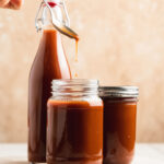 japanese worcestershire sauce dripping from a spoon into a jar