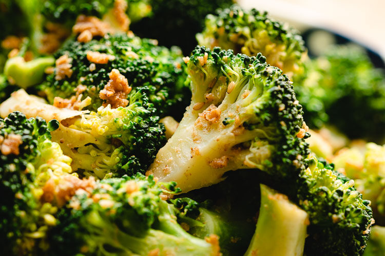 close up of broccoli gomaae on a plate