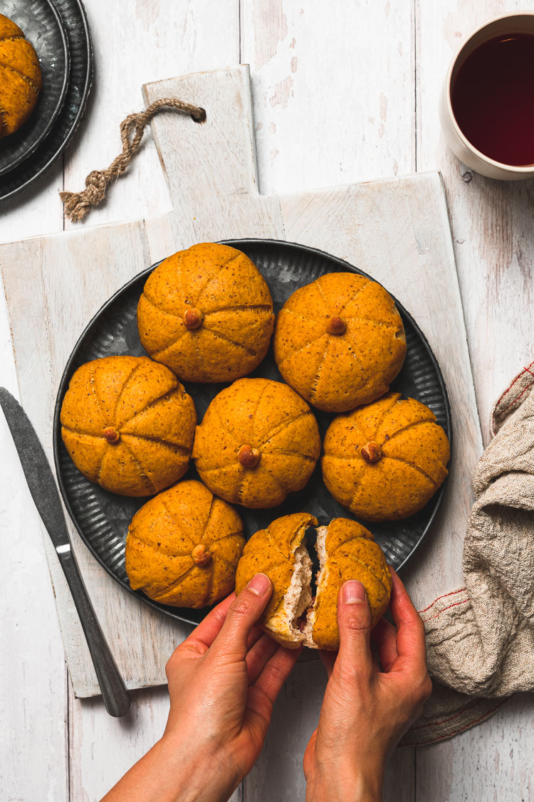 hands tearing apart a melon pan