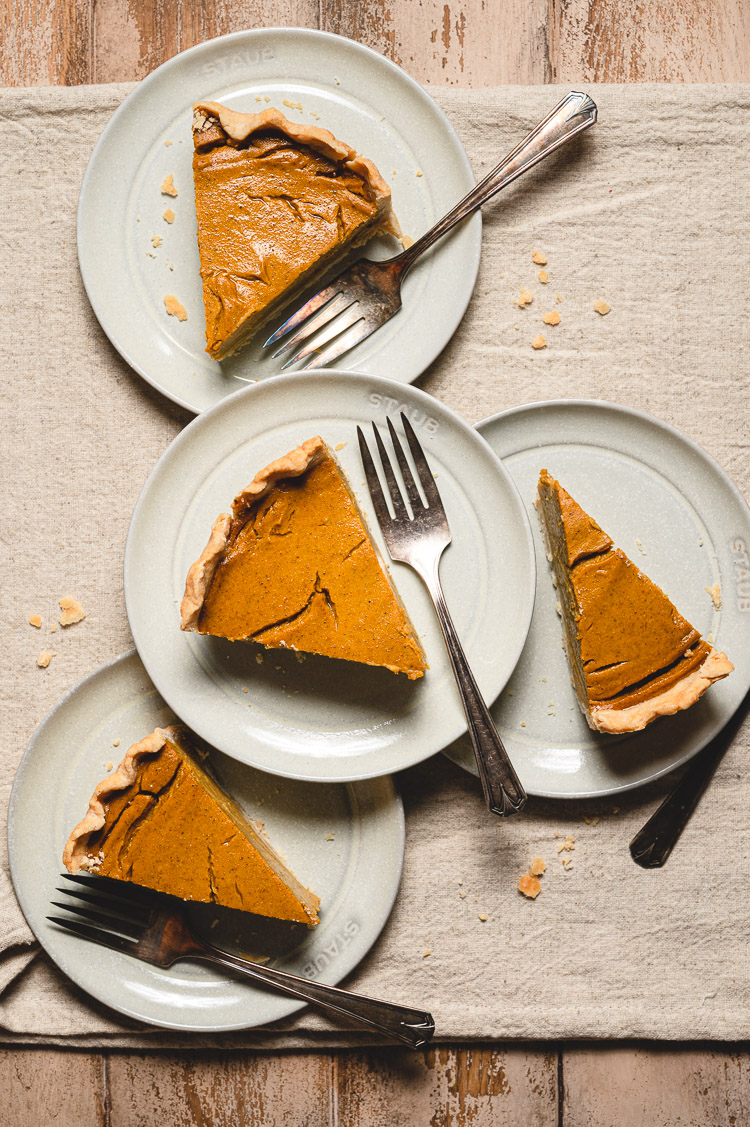 flatlay of vegan pumpkin pie slices on stacked plates