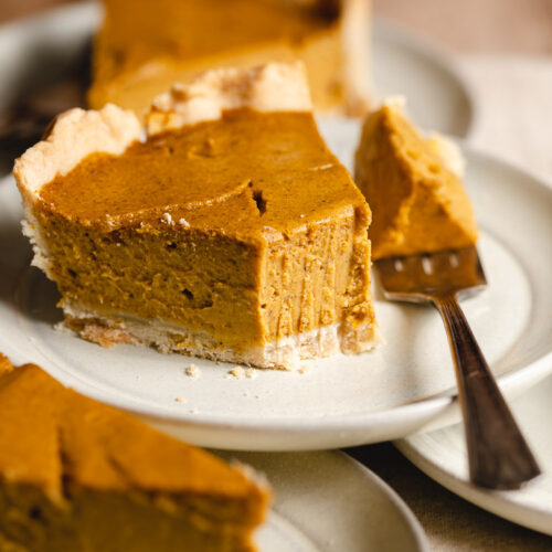 slices of vegan pumpkin pie on stacked plates