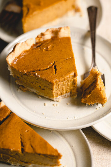 tofu pumpkin pie on a plate with bite taken out