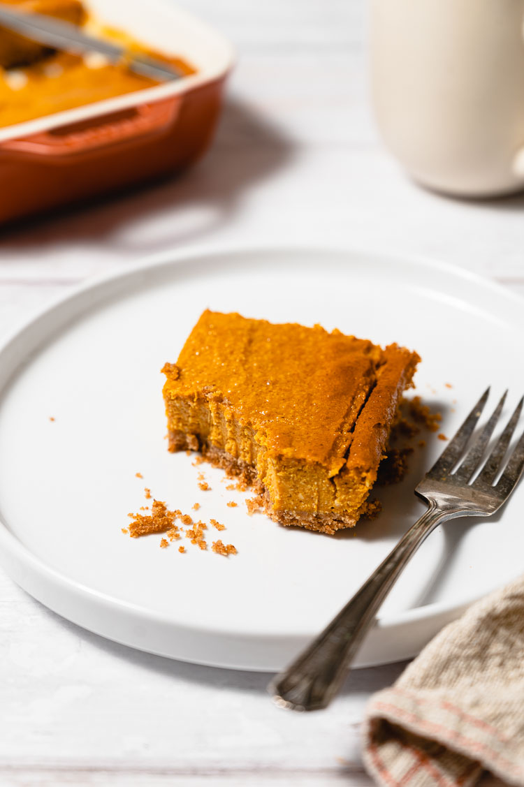 vegan pumpkin square on a plate with a bite taken out of it