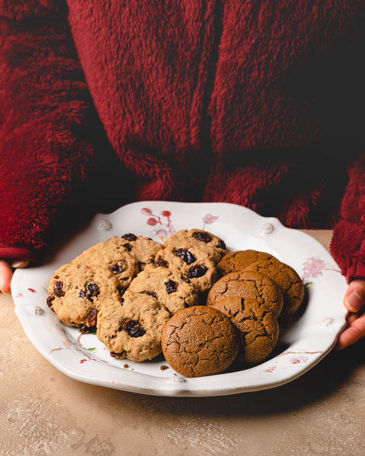 someone holding a plate of christmas cookies