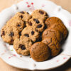 plate filled with ginger molasses cookies and oatmeal raisin cookies