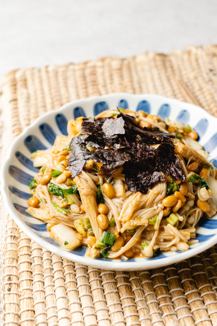 natto, kimchi, and enoki mixed on a plate, topped with nori