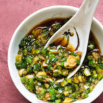 green onion sauce in a bowl with spoon