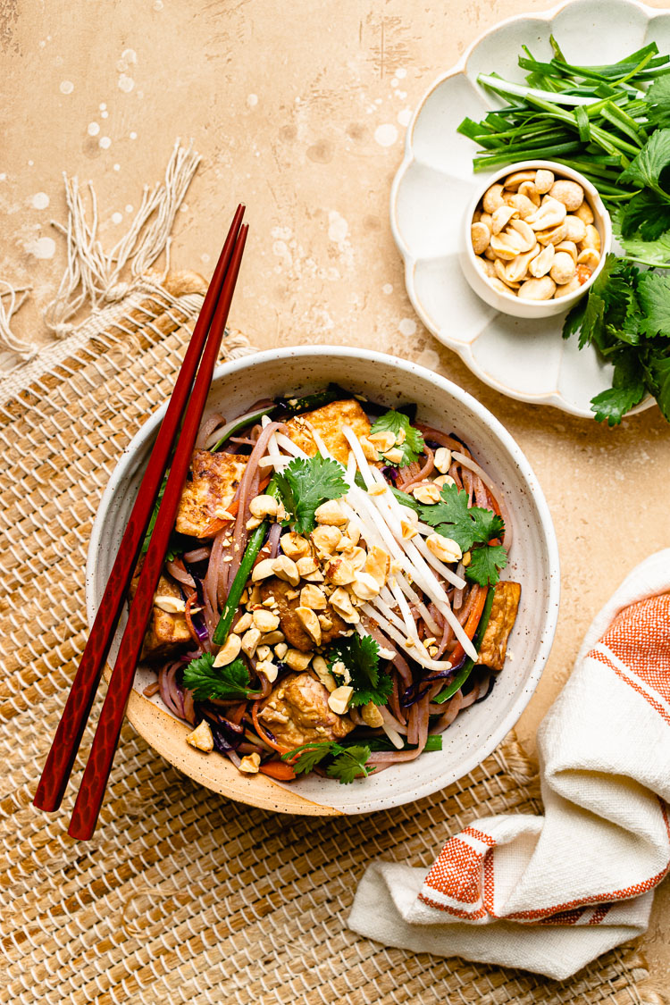 vegan pad thai in a bowl with chopsticks