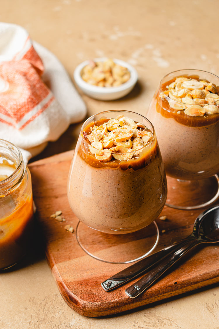 cups of snickers chia pudding on a serving board