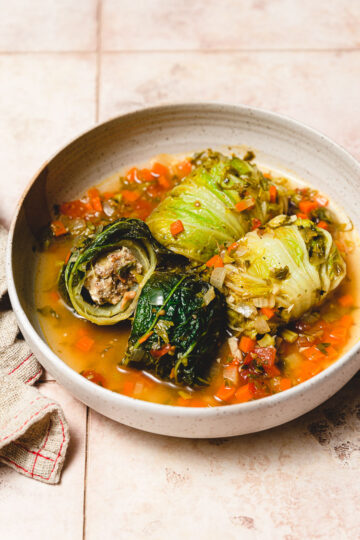 vegan cabbage rolls in a plate, cut in half