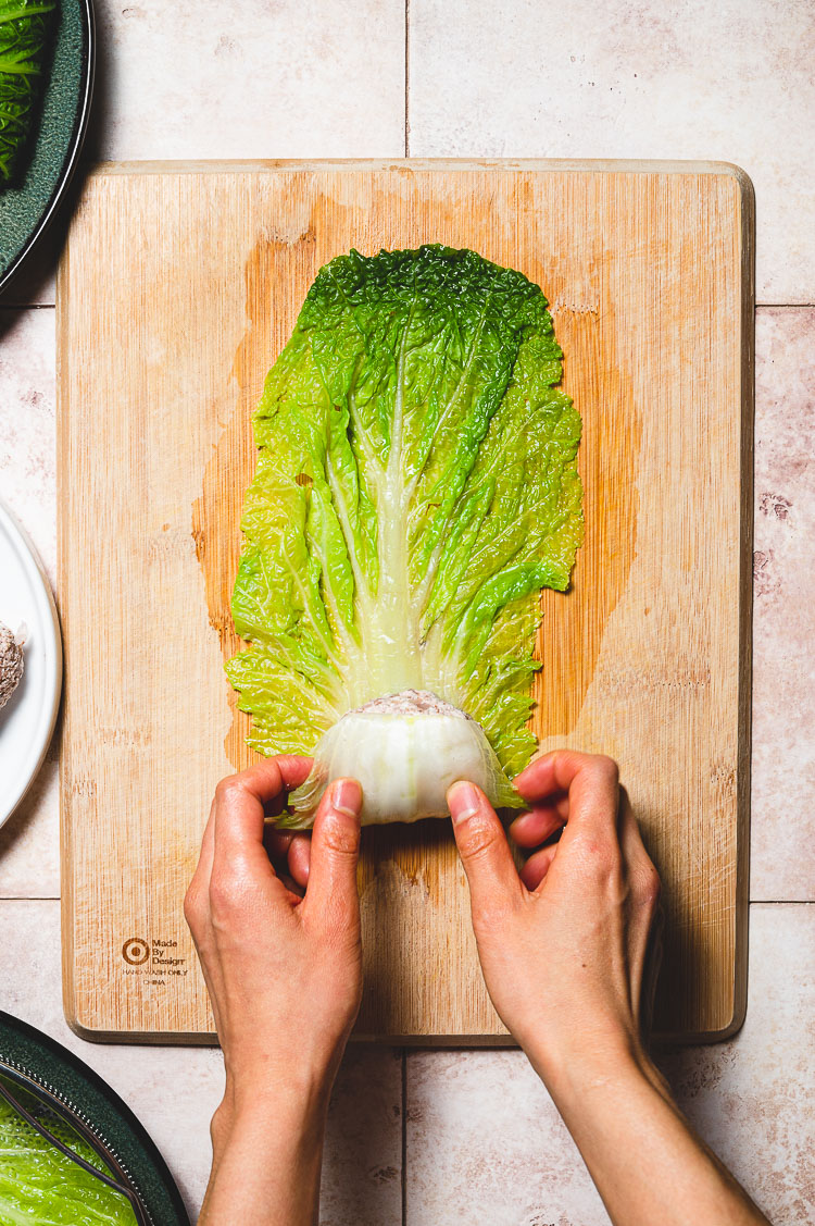 cabbage roll rolling process: bottom of cabbage leaf folding over filling
