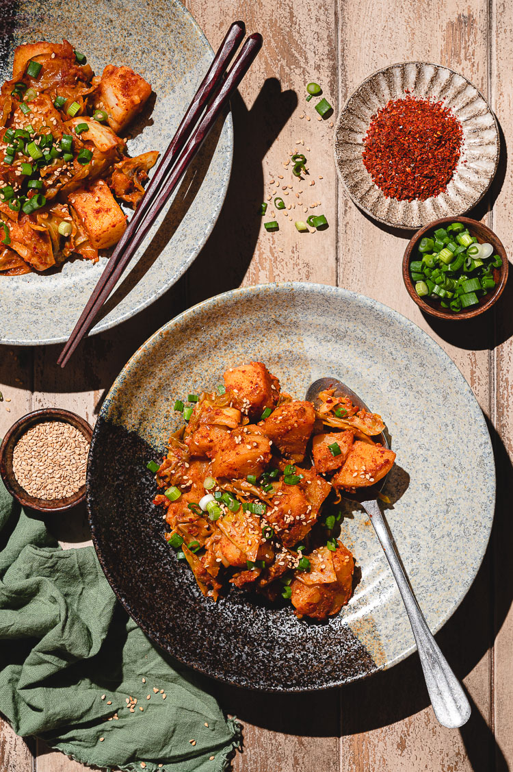 plate of gochujang potatoes shot in hard light