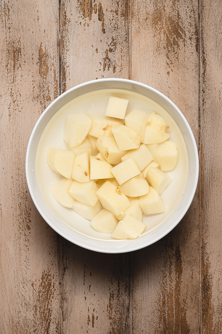 potatoes soaking in bowl of water