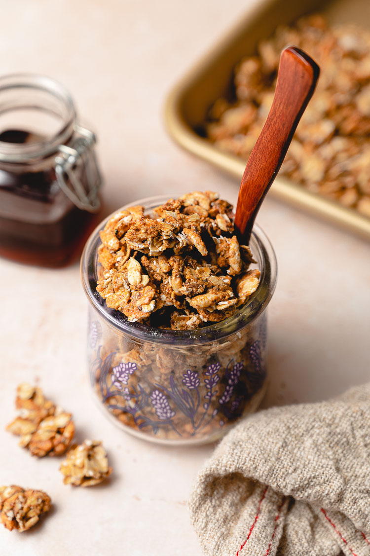 maple granola in a jar, small bottle of maple syrup on the side